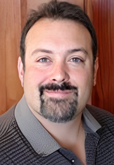 Man smiling with a goatee